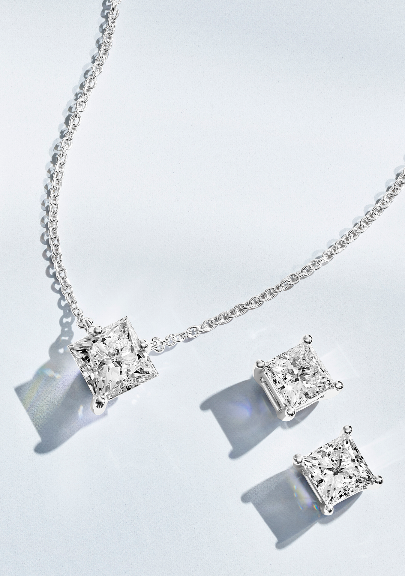 Jewelry set of white princess cut lab-grown diamond earrings and necklace