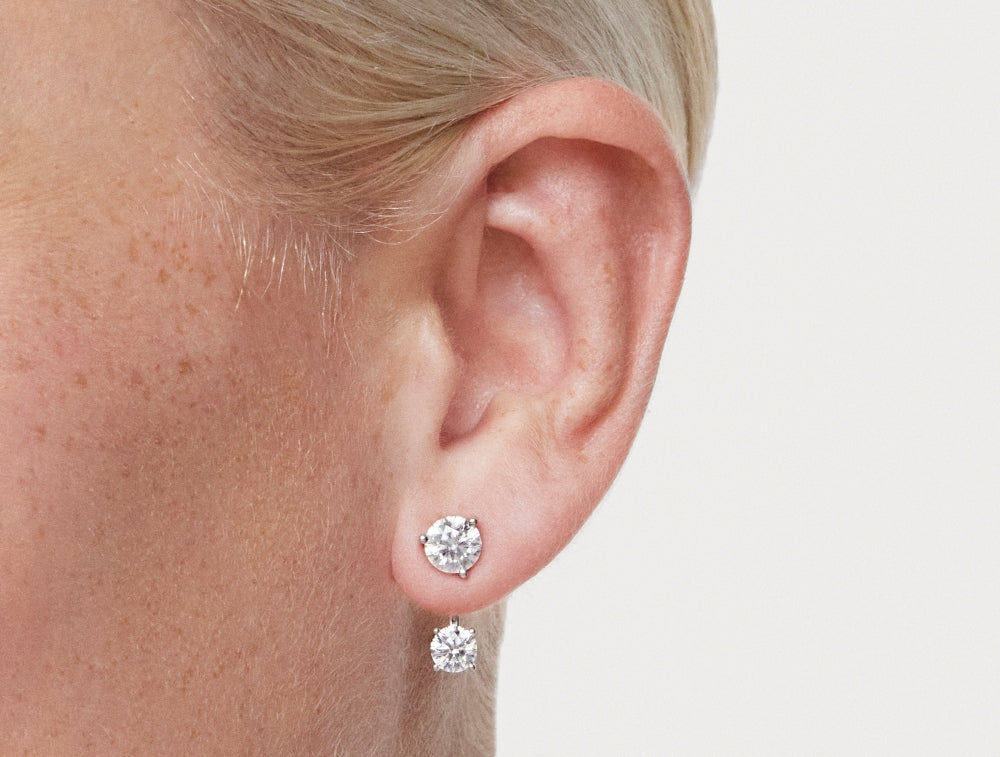 Close up model shot of 1 carat total weight earring jacket in 14k white gold with 1 carat round brilliant solitaire stud