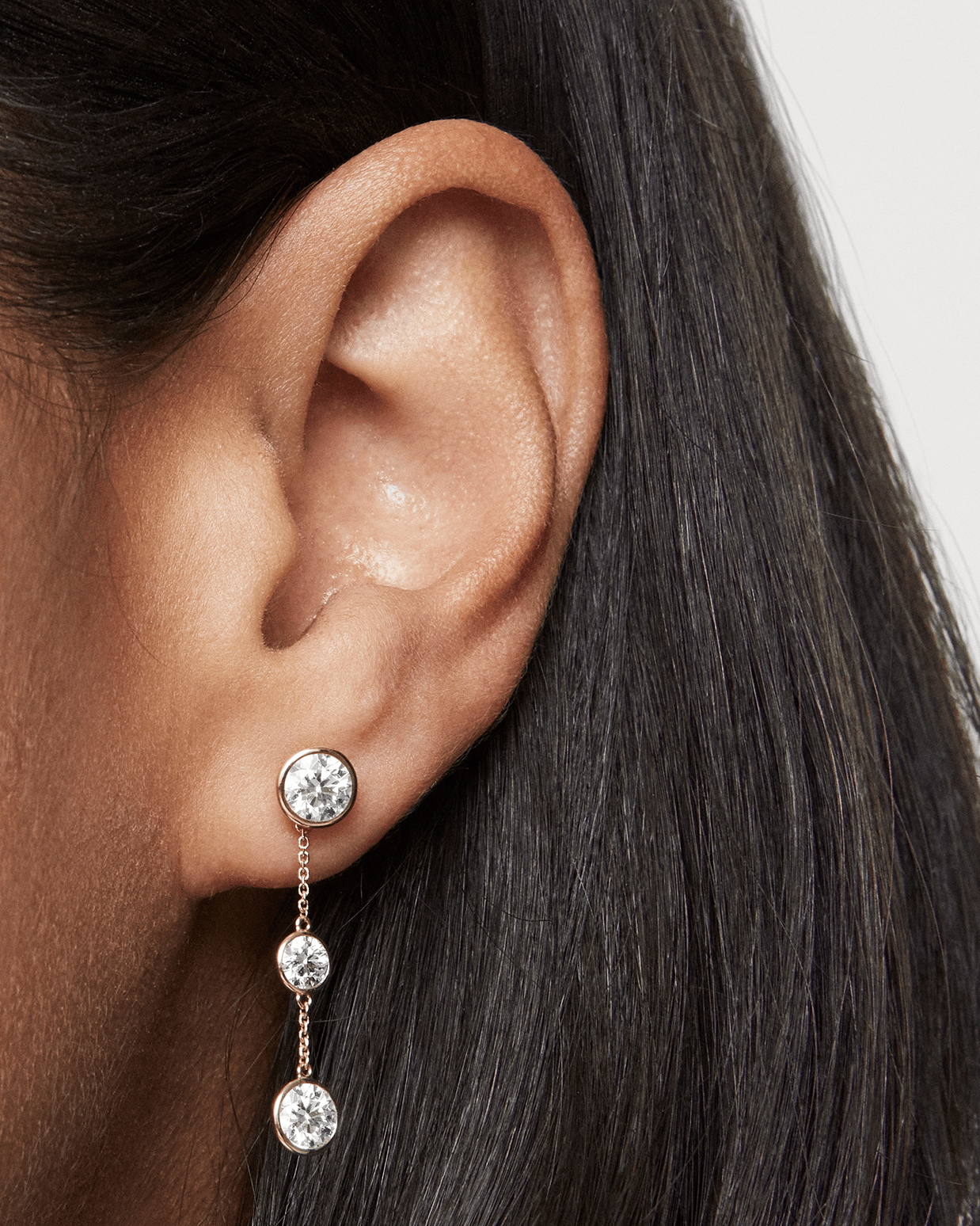 Model shot of white gold double drop bezel earring jackets