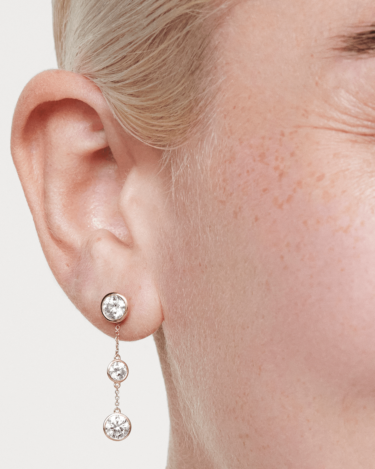 Model shot of white gold double drop bezel earring jackets