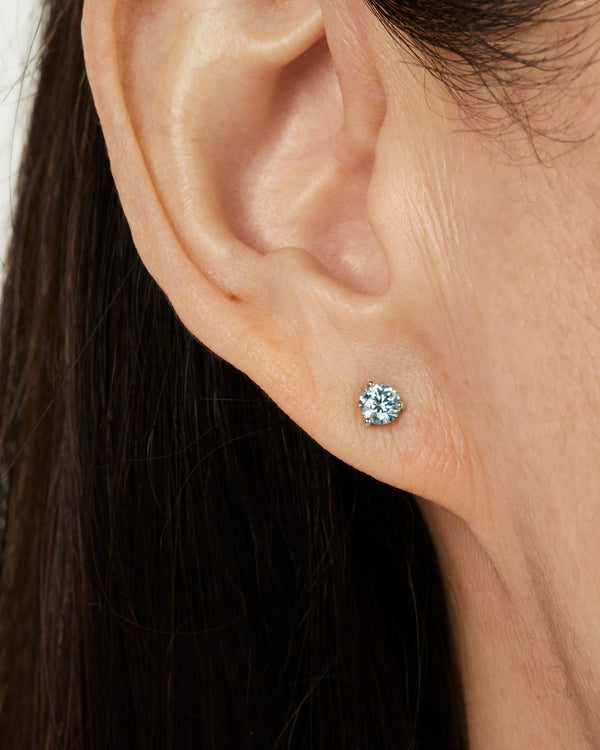 Model image of white gold, lab-grown blue 0.5 carat total weight round brilliant studs