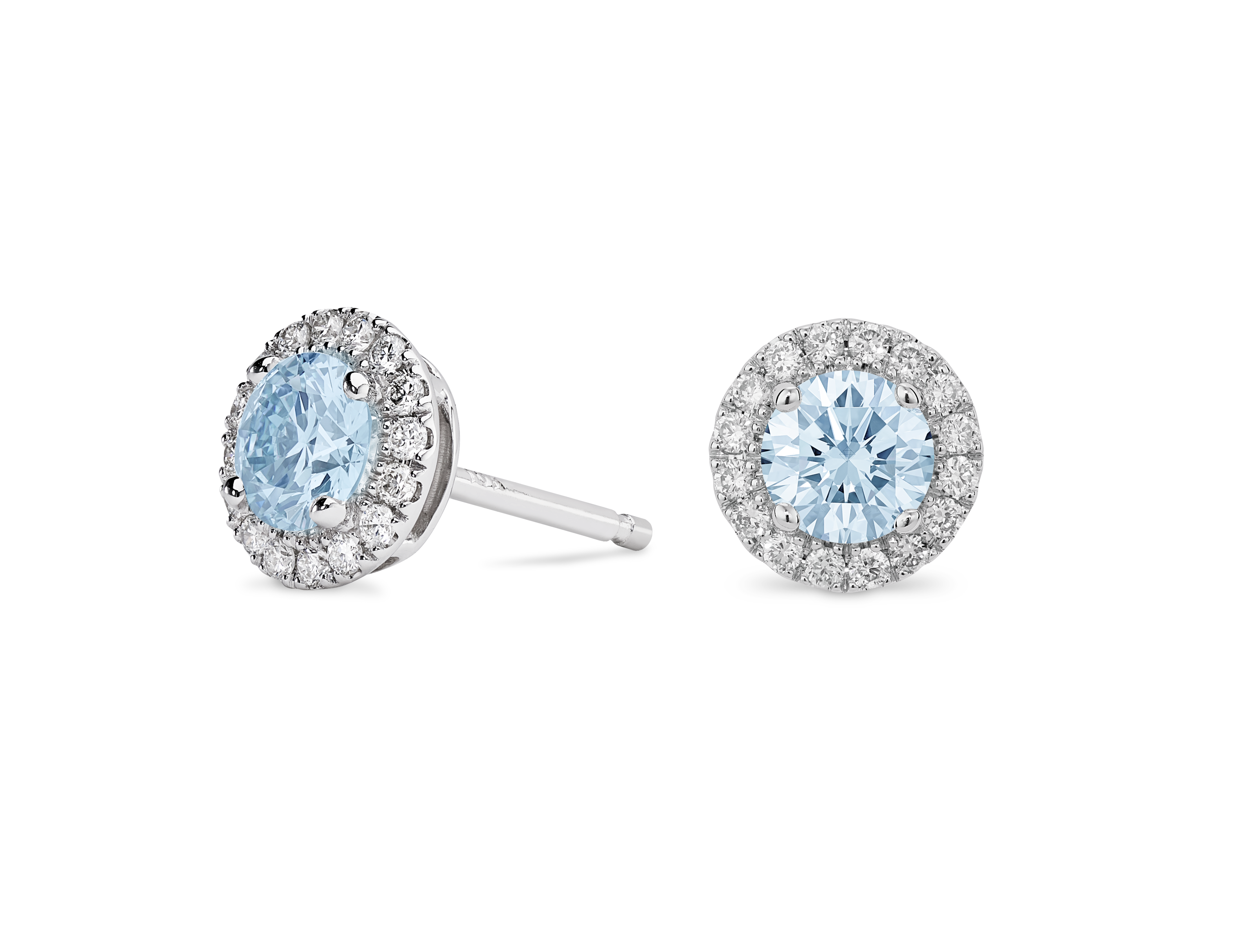 Side view of 1 carat total weight 14k white gold halo studs with blue diamonds