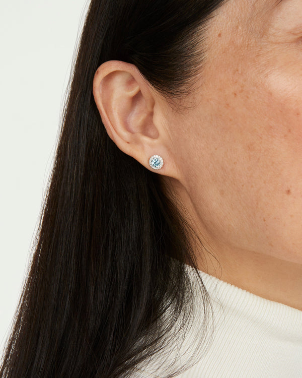 Model image of blue 1 carat total weight round brilliant halo studs