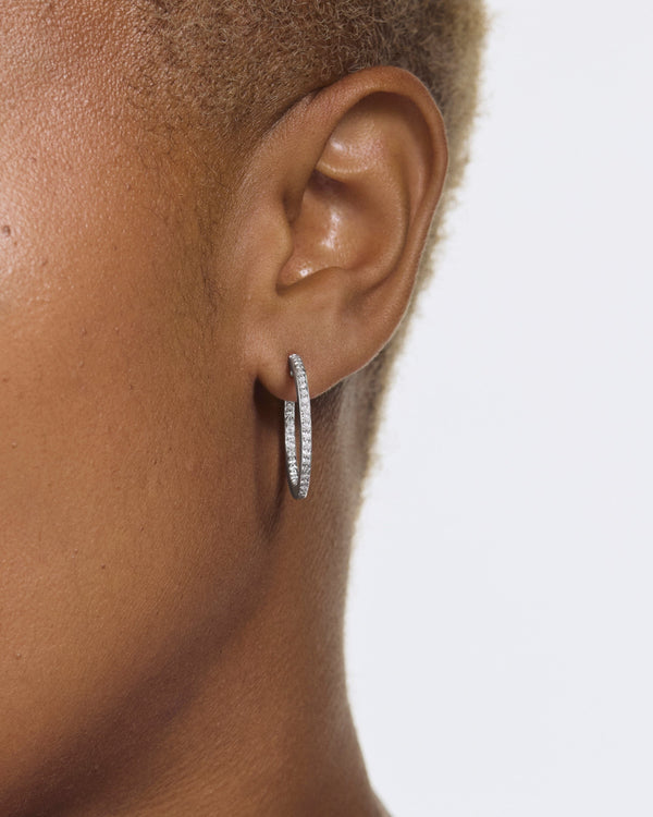 Model image of the medium pave reverse hoops in white gold