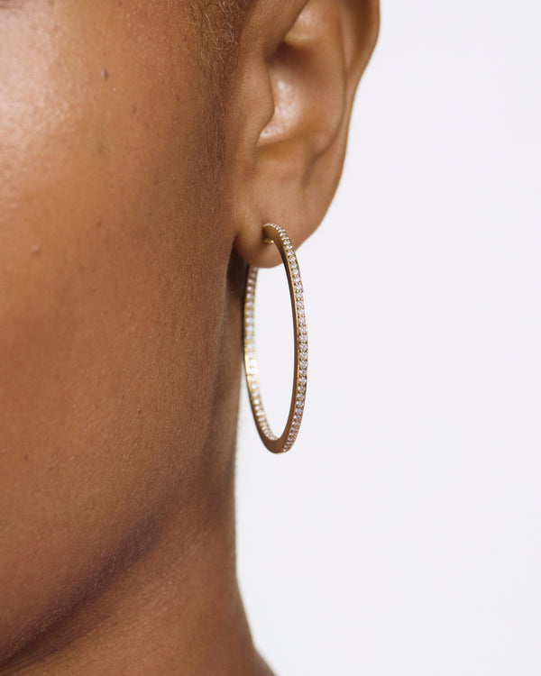 Model image of the large pave reverse hoops in yellow gold