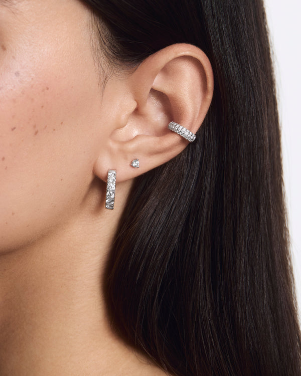 Model image of an ear stack including pavé bubble cuff, medium huggie hoop and mini stud all in white gold