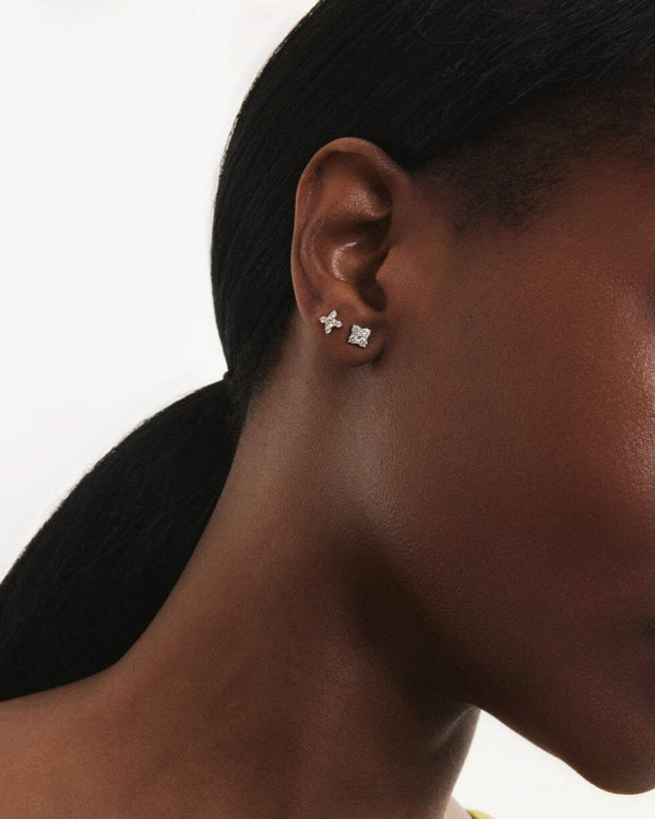 Model image of the mini leaf earring and the mini quatrefoil earring in white gold