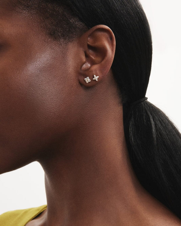 Model image of the mini leaf earring and the mini quatrefoil earring in yellow gold