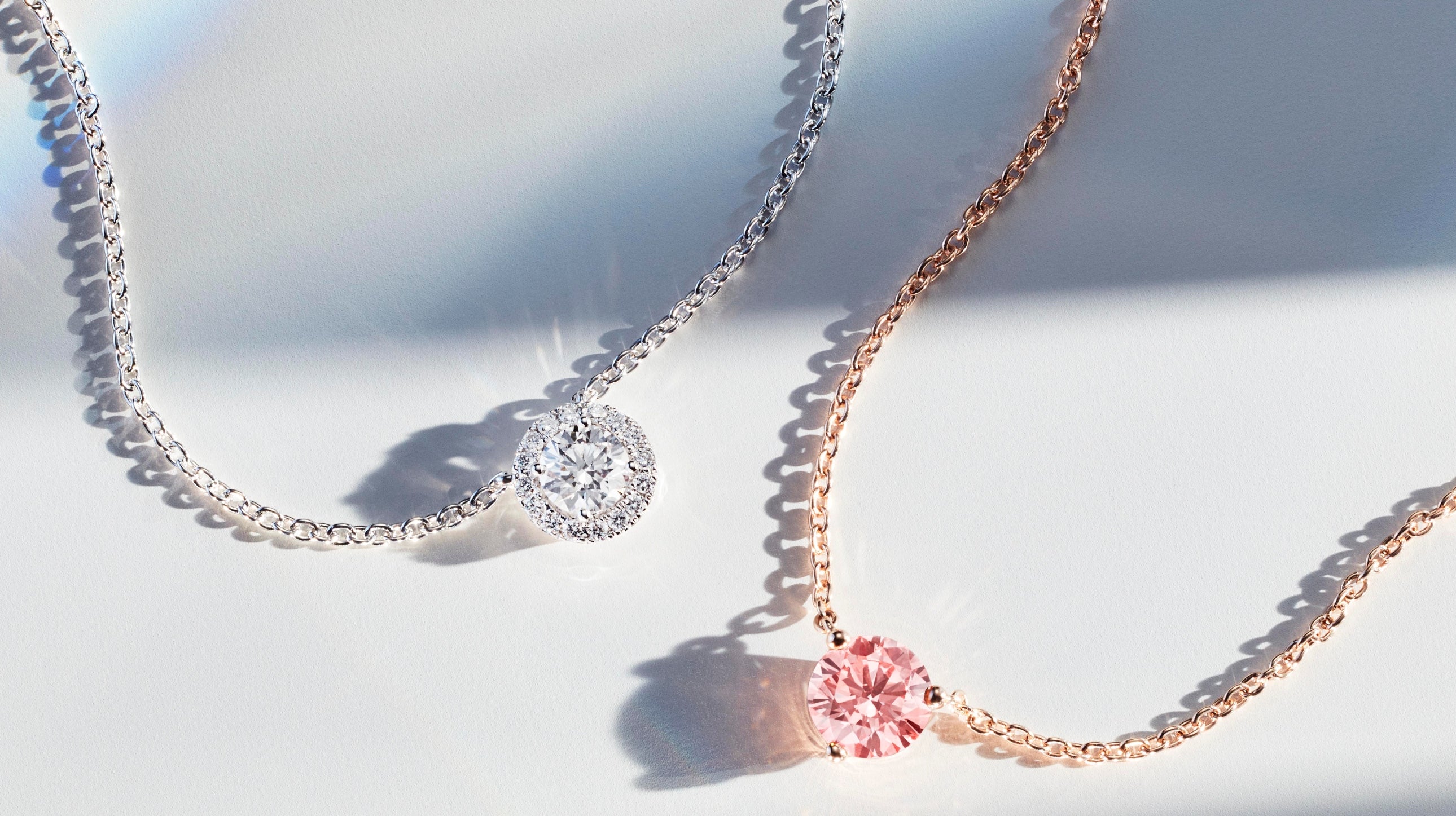 Two lab-grown diamond necklaces, white halo cut white gold pendant and pink round brilliant rose gold pendant 