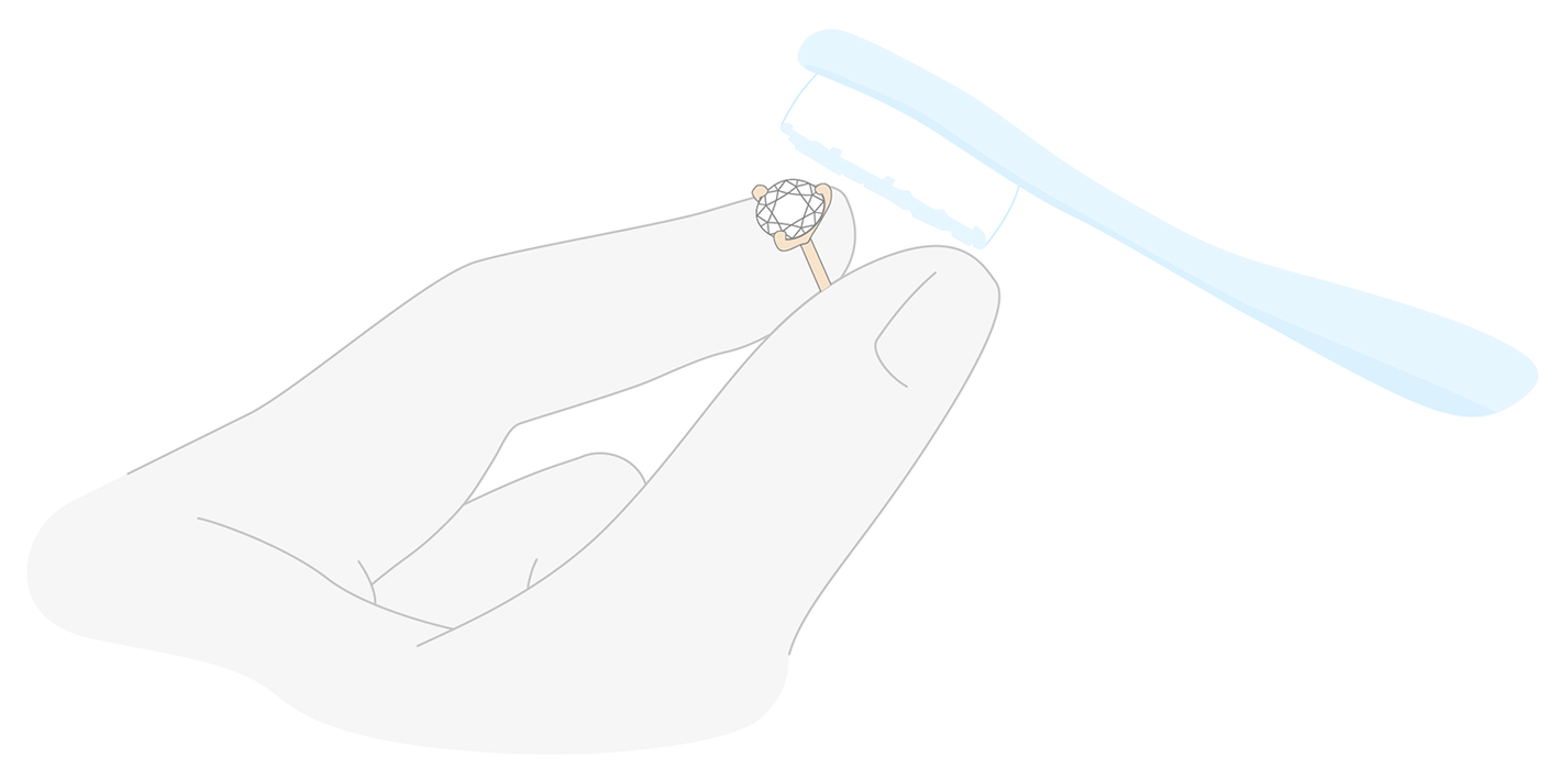 Icon of hands cleaning lab-grown diamond studs with toothbrush