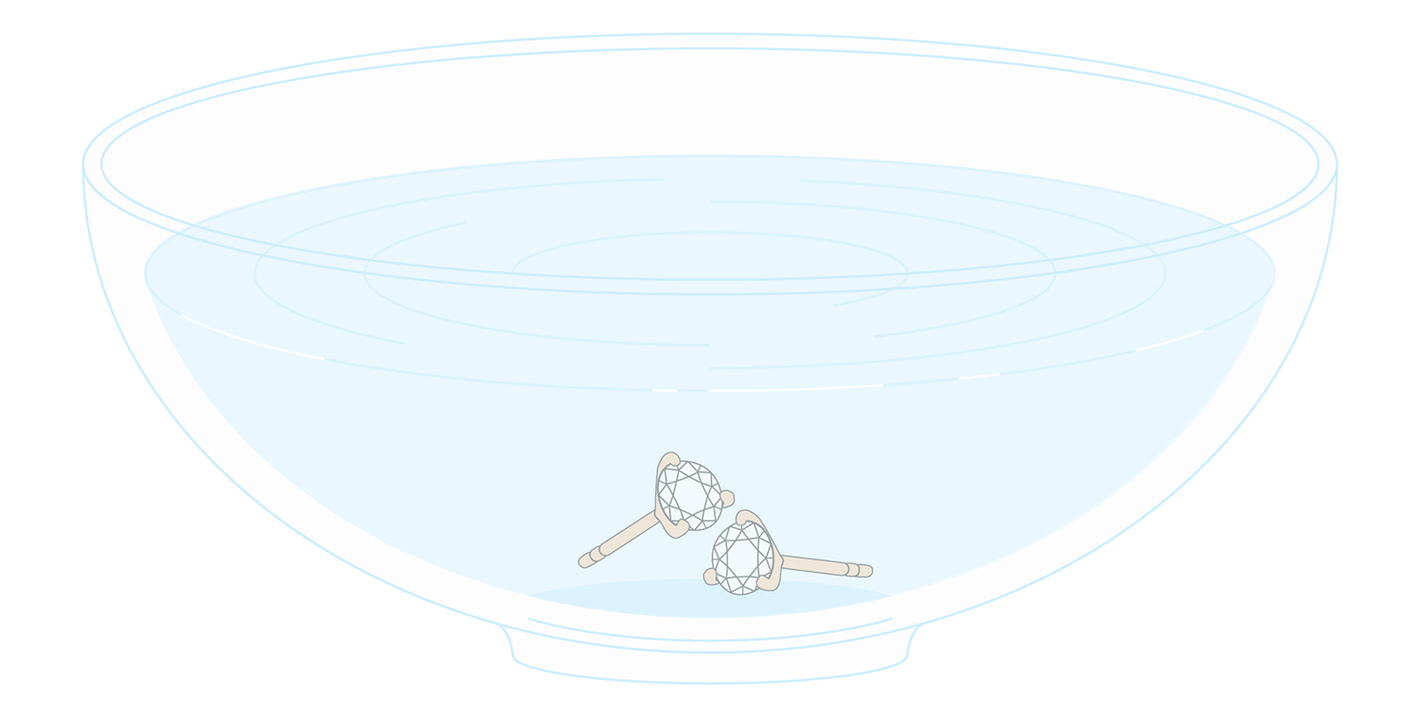 Icon of lab-grown diamond studs soaking in a bowl of water