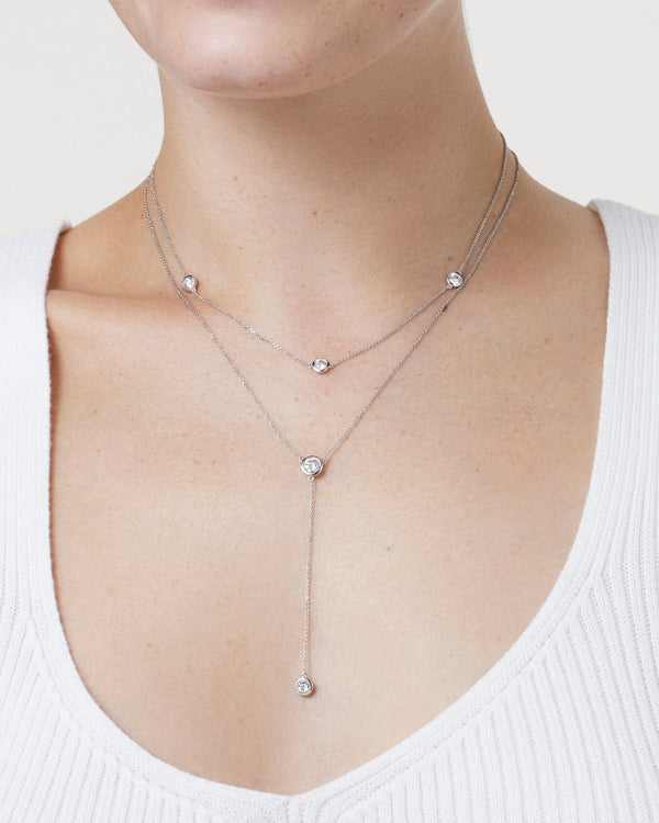 Model image of white gold station and lariat necklace layered together