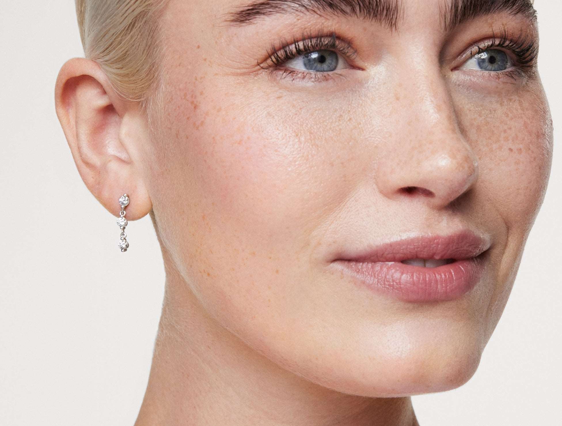 Model shot of 0.89 carat round brilliant line earrings